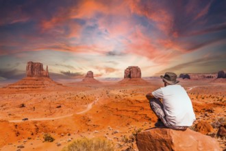 A young man in a white t-shirt in Monument Valley National Park at the visitor center at sunset,