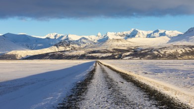 Unpaved road towards the snowy mountains of Skaftefellsjöll, near Skaftafell, Sudurland, Iceland,