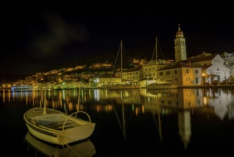 Church of St. Jerome of Stridon with rowing boat and sailboats at night, Pucišca, Split-Dalmatia