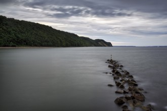 Coastal protection made of boulders, coastline on the Baltic Sea, dusk, long exposure, Baltic Sea
