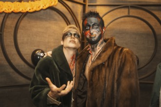 Friends in costumes at the halloween party with friends in a disco nightclub