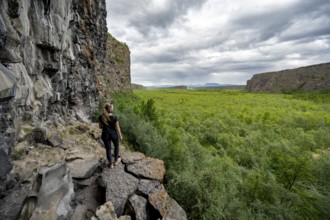 Tourist standing at the canyon, Asbyrgi Canyon, Lake Botnstjörn, lake at a cliff, Icelandic