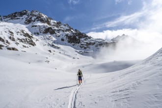 Ski tourers in a wintry mountain landscape, ascent to Porta d'Es-cha, Grisons Haute Route ski tour,