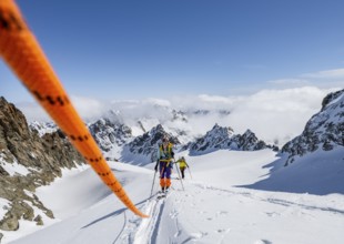 Ski tourer with rope, rope team on the Vadret da Porchabella glacier on the ascent to the summit of