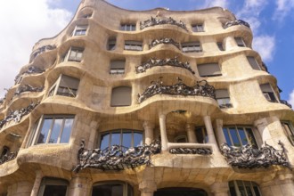 Wrought iron balconies and undulating facade of casa mila, a famous modernist building in