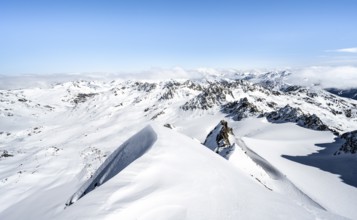 Mountain ridge of Piz Kesch, ascent on Piz Kesch or Piz d'Es-cha in winter, spectacular mountain