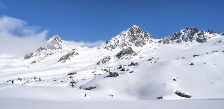 Picturesque snow-covered mountain landscape with peaks, ascent to the summit of Kesch Pitschen,