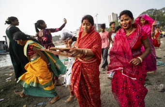 People arrives to offer prayers on the bank of Brahmaputra river on Ashoka Ashtami Festival during