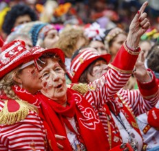Colourfully costumed carnivalists celebrate carnival in Cologne, on Weiberfastnacht the street