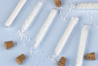 Test tubes with dropped globules and corks on a blue background