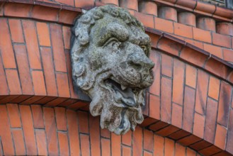 Lion head in concrete on decorative brick wall in Ystad, Skåne County, Sweden, Scandinavia, Europe