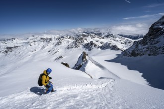 Mountaineer with ice axe and crampons, ascent through steep snowfield to Piz Kesch or Piz d'Es-cha
