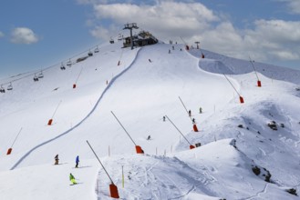 Skiers in the ski area at the summit of Corne de Sorebois, Val d'Anniviers, Valais Alps, Canton