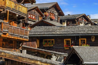 Old wooden houses decorated with flowers in the historic village centre, Grimentz, Val d'Anniviers,