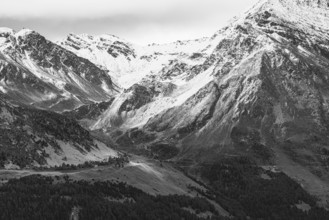 Dark clouds over the snow-covered mountains, black and white photo, above Saint Luc, Val
