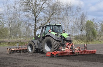 Tractor with harrows, disc harrows during tillage