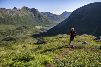 Mountaineers on a hiking trail to the summit of Rundfjellet, mountain landscape and valley with