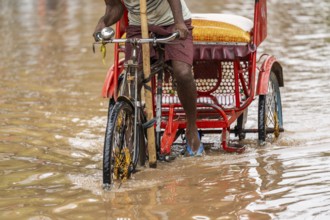 Commuters wade through a flooded street after heavy rains in Guwahati, India on April 28, 2025