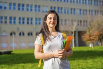 Portrait of beautiful smiling female college student in the campus