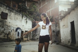 Mother with her son in the Petare slum, Caracas, Venezuela, South America