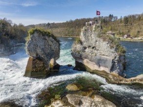 Aerial view of the Rhine Falls at low water in spring, with tourists on the viewing platform,