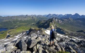 View of mountains and fjord landscape, mountain panorama, mountaineer at the summit of Rundfjellet,