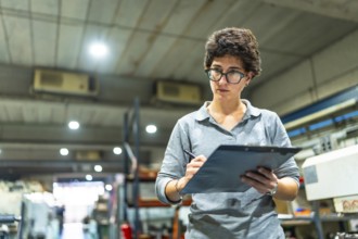 Caucasian adult woman checking quality of products in a cnc metallurgic factory