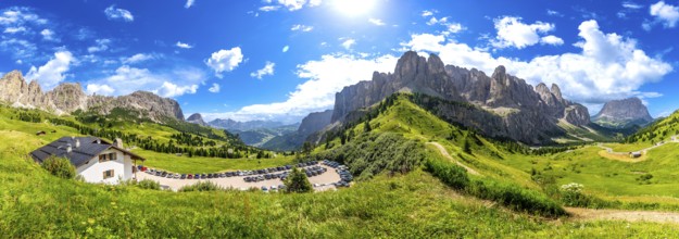 Breathtaking panorama of the dolomites in summer, showcasing lush green valleys, rugged peaks, and