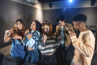 Friends dancing and having fun at a movie disco event, enjoying music and entertainment in a cinema