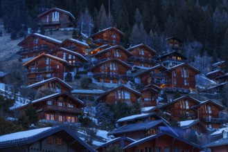 Chalets built into the hillside as holiday homes at dusk, Grimentz, Val d'Anniviers, Valais Alps,