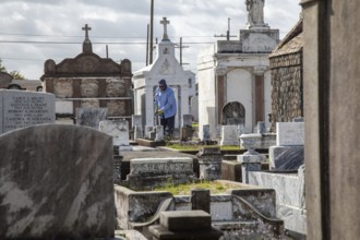 New Orleans, Louisiana - A groundskeeper at work in St. Joseph Cemetery #1, established in 1854.