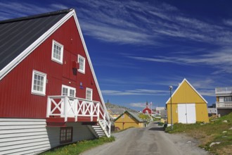 Colourful Scandinavian houses along a quiet street under a blue sky, old town of the capital of