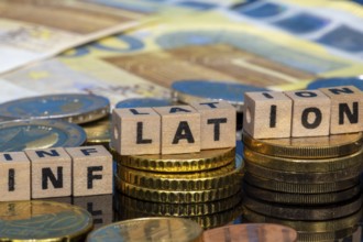 Symbolic image of inflation: euro coins and letters displaying the word INFLATION