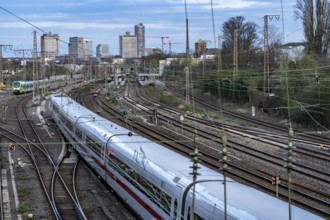 Train on the tracks west of Essen central station, skyline of the city centre, ICE train, North