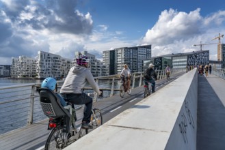 Cyclists on the Bryggebroen cycle and footpath bridge over the harbour, Sydhavnen, Copenhagen is