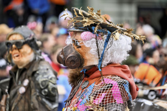 Person dressed up as a soldier with a gas mask at the Wey guild on Rose Monday, Güdismäntig,