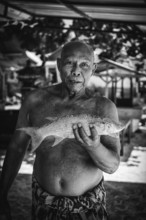 Indonesian fishmonger at a market, fish, man, food, foodstuff, local, travel, long distance,