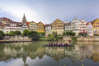Neckarfront Tübingen with punt on the Neckar. Postcard motif with historic buildings and collegiate
