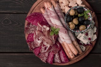 Appetizer, assortment, set, sausage, and cheese, on a wooden board, top view, no people