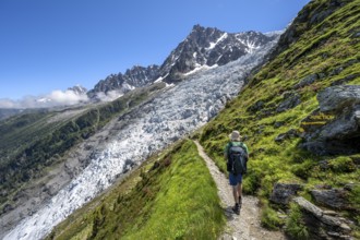 Hiking on the trail to La Jonction, Glacier des Bossons, behind the summit of the Aiguille du Midi,