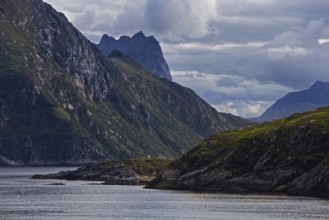 Dramatic coastline with green slopes and clouds over Bergen, Norway, Europe