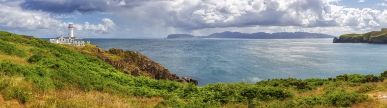 Panoramic view of the sea with a lighthouse and islands under a cloudy sky, Fanad Head Lighthouse