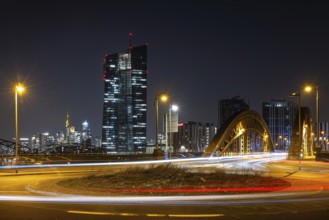 The lights of the European Central Bank (ECB) and the Frankfurt banking skyline glow in the