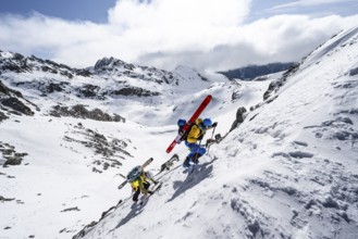 Climbers with skis ascending a steep snow slope to the Porta d'Es-cha saddle, Bündner Haute Route