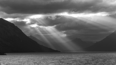 Black and white image of sunbeams and light mood at sunset at Lago Huechulafquen, Lanin National