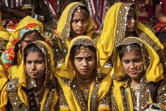 PUSHKAR, INDIA, NOVEMBER 21, 2012: Unidentified Rajasthani girls in traditional outfits prepare for