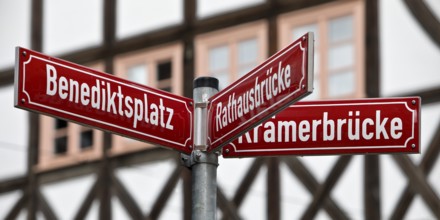 Red street signs in front of half-timbered houses in the old town, Erfurt, Thuringia, Germany,