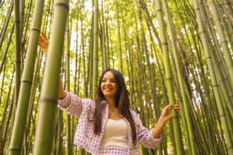 Young caucasian girl with a pink skirt in a bamboo forest. Enjoying summer holidays in a tropical