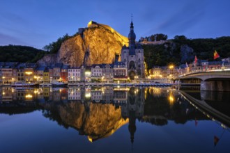 Night view of Dinant town, Collegiate Church of Notre Dame de Dinant over River Meuse and Pont