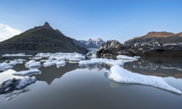 Reflection in the Svínafellslon glacier lagoon with ice floes, Svínasfellsjökull glacier tongue,